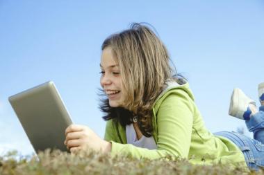 girl using digital tablet outdoors
